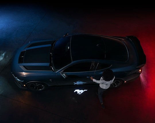 2024 Ford Mustang® Dark Horse™ model with a driver approaching the vehicle | Big Valley Ford, Inc. in Ewen MI