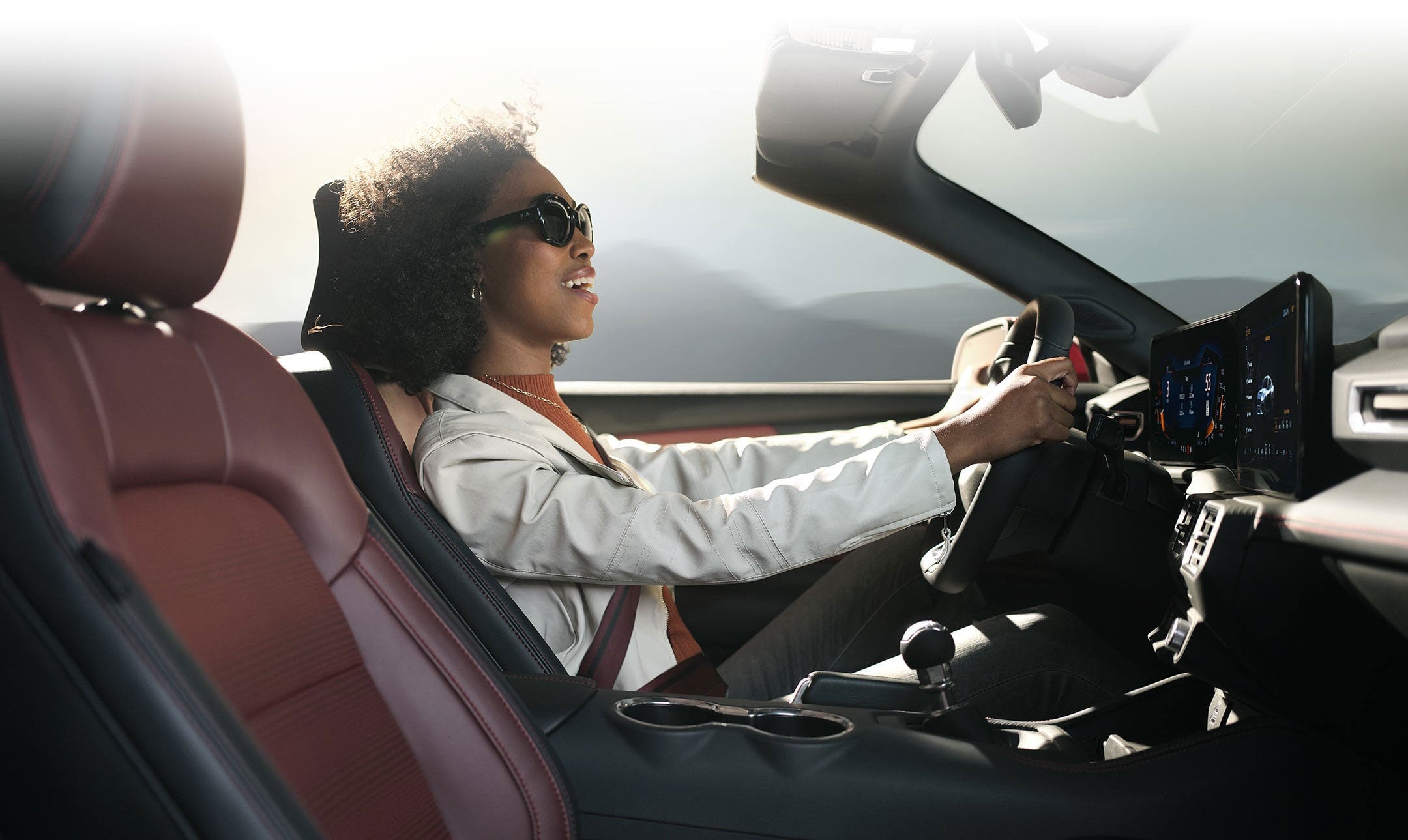 Person sitting in the driver’s seat of a 2024 Ford Mustang® convertible | Big Valley Ford, Inc. in Ewen MI