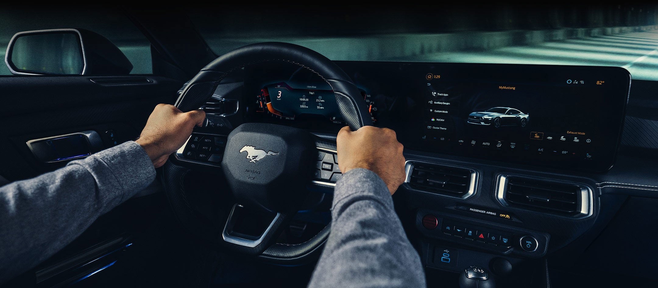 A 2024 Ford Mustang® model interior with a person driving | Big Valley Ford, Inc. in Ewen MI